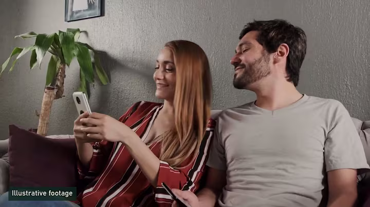 Two people looking at a phone, from the episode about age checks